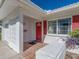 Red front door, tiled porch, and white exterior at 14181 89Th Ave, Seminole, FL 33776
