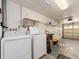 Garage with washer, dryer, and storage shelving at 14181 89Th Ave, Seminole, FL 33776