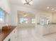 Bright kitchen features white cabinets, granite countertops, and tile floors at 14181 89Th Ave, Seminole, FL 33776