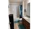 Clean bathroom with tub shower, granite vanity, and tile flooring at 14207 Alistar Manor Dr, Wimauma, FL 33598