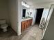 Double vanity bathroom with granite countertops and tiled floors at 14207 Alistar Manor Dr, Wimauma, FL 33598