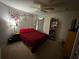 Bedroom with a queen-size bed, nightstand, and a bookshelf at 14207 Alistar Manor Dr, Wimauma, FL 33598