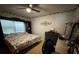 Spacious bedroom with a large bed, dresser and ceiling fan at 14207 Alistar Manor Dr, Wimauma, FL 33598