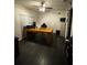 Home office with large desk, comfortable chair, and dark hardwood floors at 14207 Alistar Manor Dr, Wimauma, FL 33598