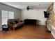 Living room with hardwood floors, a sectional sofa, and a rustic wall accent at 14207 Alistar Manor Dr, Wimauma, FL 33598