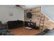 Living room with dark brown sofa and a rustic wood accent wall at 14207 Alistar Manor Dr, Wimauma, FL 33598