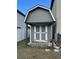 Gray shed with white trim and double doors in a backyard at 14207 Alistar Manor Dr, Wimauma, FL 33598