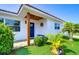 Inviting front entrance with a blue door, wood accent, and landscaping at 220 45Th Ave, St Pete Beach, FL 33706