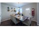 Bright dining room with wood table and four chairs, adjacent to kitchen at 2408 E Chelsea St, Tampa, FL 33610