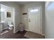 Entryway with half bathroom and wood-look floors at 2408 E Chelsea St, Tampa, FL 33610