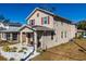 Two-story house with tan exterior, red shutters, covered porch, and well-maintained landscaping at 2408 E Chelsea St, Tampa, FL 33610