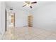 Bedroom with tile floors, ceiling fan, and access to bathroom at 2650 Pearce Dr # 403, Clearwater, FL 33764