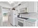 White kitchen with ample counter space, microwave, and oven at 2650 Pearce Dr # 403, Clearwater, FL 33764