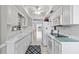 Bright kitchen with white cabinets, modern appliances, and tiled floors at 2650 Pearce Dr # 403, Clearwater, FL 33764