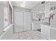 White kitchen with a window overlooking the outdoors and tiled floors at 2650 Pearce Dr # 403, Clearwater, FL 33764