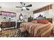 Spacious bedroom with a king-size bed, antique furniture, and a ceiling fan at 3058 Merrill Ave, Clearwater, FL 33759