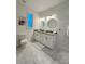 Elegant bathroom with double vanity, granite countertops, and marble-look tile at 3208 Deleuil Ave, Tampa, FL 33610