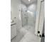 Modern bathroom featuring a frameless shower, marble tile, and double vanity at 3208 Deleuil Ave, Tampa, FL 33610