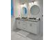 Double vanity bathroom with granite countertop, white cabinets, and circular mirrors at 3208 Deleuil Ave, Tampa, FL 33610