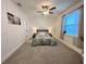 Large bedroom with plush carpet, a gray bed, and ample natural light at 3208 Deleuil Ave, Tampa, FL 33610