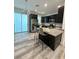 Modern kitchen with stainless steel appliances and granite countertops at 3208 Deleuil Ave, Tampa, FL 33610