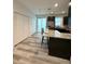 Modern kitchen with granite countertops and island seating at 3208 Deleuil Ave, Tampa, FL 33610