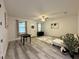 Bright living room featuring a large window, foosball table, and a sectional sofa at 3208 Deleuil Ave, Tampa, FL 33610