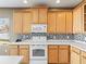 White appliances and wood cabinets in this kitchen at 474 Rockrose Ct, Spring Hill, FL 34609