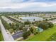 Aerial view of community with lake and homes at 4904 Barnstead Dr, Riverview, FL 33578