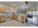 Open kitchen with light wood cabinets and white appliances at 4904 Barnstead Dr, Riverview, FL 33578
