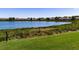 Community lake view with green space and townhomes in the background at 4904 Barnstead Dr, Riverview, FL 33578