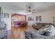 Open concept living and dining area with a comfortable sectional sofa and hardwood floors at 4904 Barnstead Dr, Riverview, FL 33578
