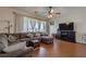 Bright living room with a sectional sofa, hardwood floors, and a fireplace at 4904 Barnstead Dr, Riverview, FL 33578