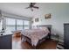 Main bedroom with lake view, king-size bed, and ample natural light at 4904 Barnstead Dr, Riverview, FL 33578