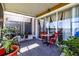 Peaceful screened patio with lake view and wooden table at 4904 Barnstead Dr, Riverview, FL 33578