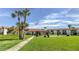 Community features lush green space, a flag, and palm trees at 5135 Gemstone Dr # 206, New Port Richey, FL 34652