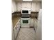 Efficient kitchen with white cabinets and appliances at 5135 Gemstone Dr # 206, New Port Richey, FL 34652