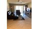 Spacious living room with leather furniture and tiled floors at 5135 Gemstone Dr # 206, New Port Richey, FL 34652