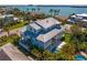 Aerial view of luxurious home, showcasing its metal roof, backyard pool, and waterfront location at 6189 Leeland S St, St Petersburg, FL 33715