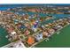 Expansive aerial view showcasing waterfront home with lush tropical foliage at 6189 Leeland S St, St Petersburg, FL 33715