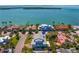Gorgeous aerial view showcasing the luxurious home with metal roof, pool, and bay views at 6189 Leeland S St, St Petersburg, FL 33715