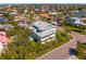 Wide aerial shot of neighborhood featuring luxurious home with landscaping, metal roof, and coastal charm at 6189 Leeland S St, St Petersburg, FL 33715