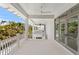 Spacious covered balcony with white railings, offering views of lush tropical foliage at 6189 Leeland S St, St Petersburg, FL 33715