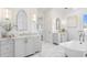 Elegant bathroom with dual vanities, marble floors, a clawfoot tub, and modern light fixtures at 6189 Leeland S St, St Petersburg, FL 33715