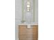 Modern bathroom vanity with light wood cabinets, marble countertop, decorative mirror and elegant pendant lights at 6189 Leeland S St, St Petersburg, FL 33715