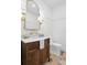 Classic half-bathroom with dark wood vanity, marble countertop, and decorative lighting at 6189 Leeland S St, St Petersburg, FL 33715