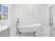 Serene bathroom features a vintage-style tub, marble floors, and a bright window at 6189 Leeland S St, St Petersburg, FL 33715