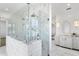 Stunning bathroom showcasing a glass enclosed shower with dual shower heads and marble herringbone tile at 6189 Leeland S St, St Petersburg, FL 33715