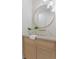 Modern bathroom features a round mirror, unique wall-mounted faucet, and a stylish vanity at 6189 Leeland S St, St Petersburg, FL 33715