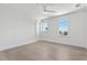 Spacious bedroom with hardwood floors, bright windows, and clean white walls at 6189 Leeland S St, St Petersburg, FL 33715